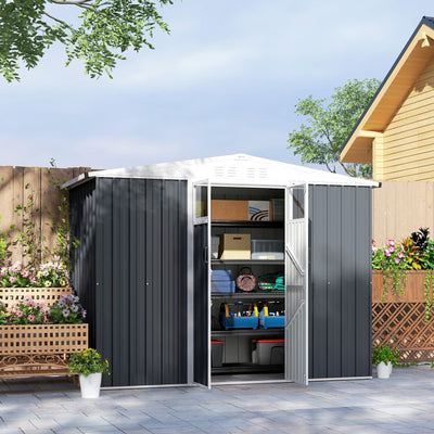 Dark grey shed on a patio with both doors open showing boxes and tools on shelving inside