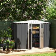 Dark grey shed on decking with the double doors open showing crates and storage boxes