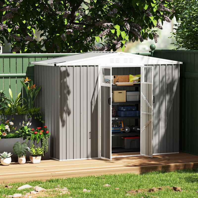 Light grey shed on decking with the doors open showing crates and boxes stacked inside