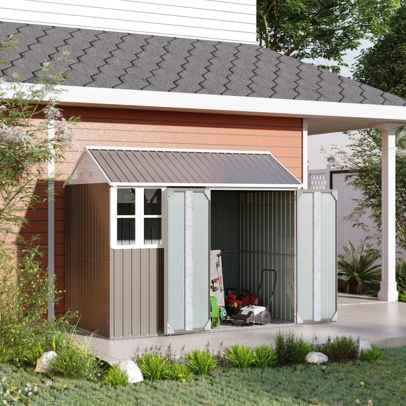 Grey shed beside a house with both doors open showing a mower and garden tools