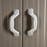 Close-up of the pair of white moulded handles on the shed double doors