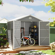 Light grey plastic shed on decking with doors open, holding a bike and a loaded shelving unit
