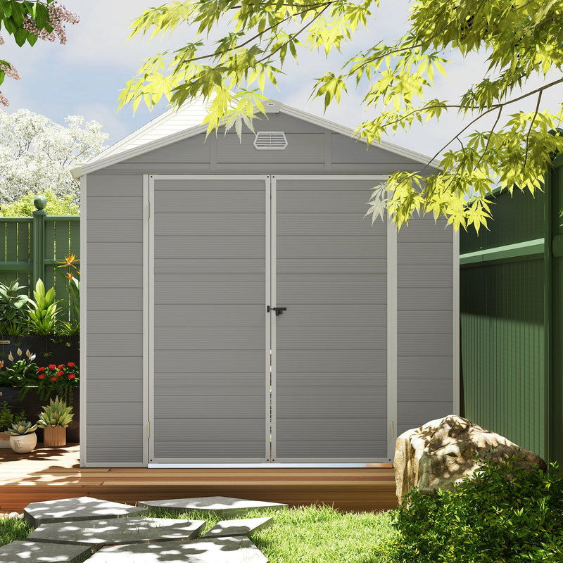 Light grey shed seen head-on with both doors closed and latched, in a planted garden
