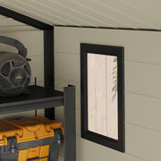 Inside wall of the shed with the window beside a shelf holding a leaf blower and tool box