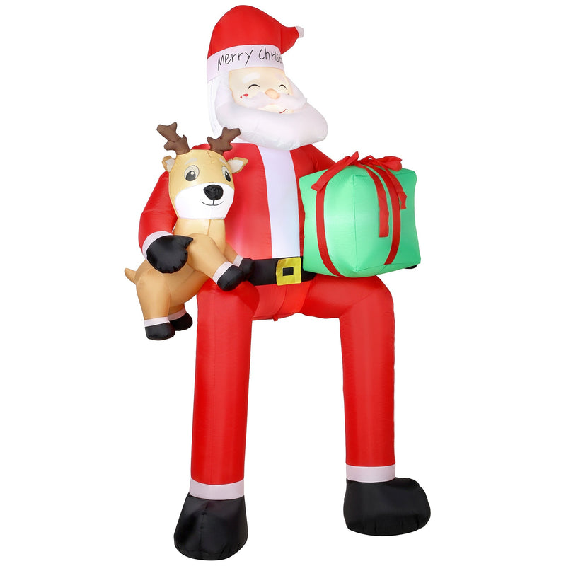 Inflatable Santa Claus sitting with a reindeer and green gift box on a white background
