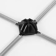 Close-up of a black plastic connector joining the metal rods and white panels