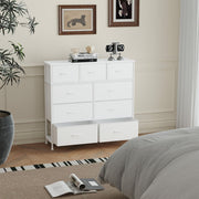 White 9-drawer chest in a bedroom with the two bottom drawers pulled fully open