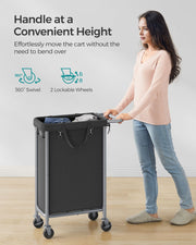 Woman pushing the laundry basket by its handle showing the swivel and lockable wheels