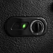Close-up of the black chest freezer's temperature dial and green run indicator