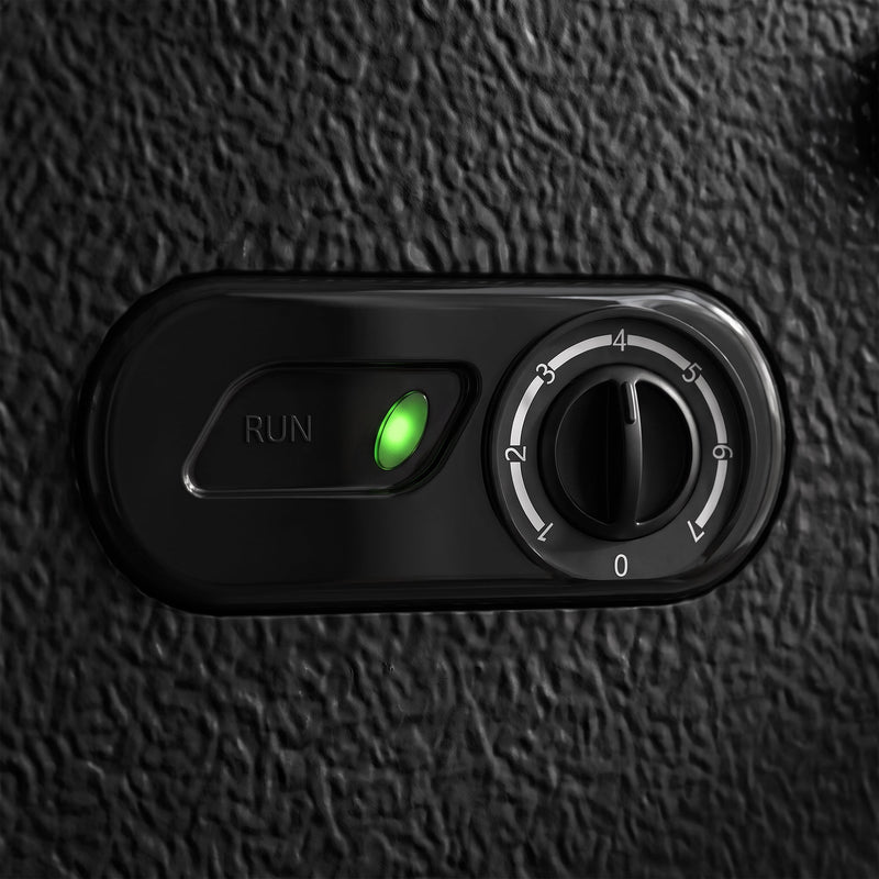Close-up of the black chest freezer's temperature dial and green run indicator