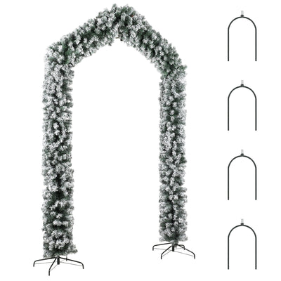 Snow-flocked Christmas tree arch with four metal ground stakes on a white background