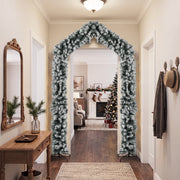 Flocked Christmas arch in a hallway with a console table and coat hooks
