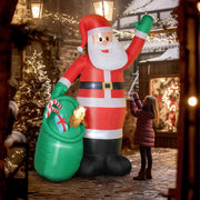 Child looking at the inflatable Santa in a festive street at night