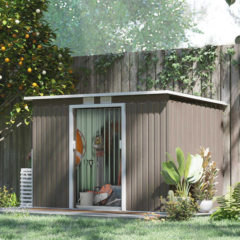 Brown shed in a garden with the sliding door open showing tools and pots stored inside