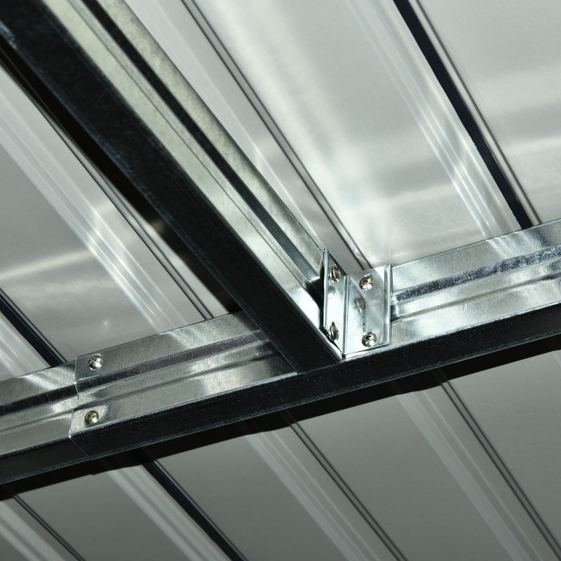 Close-up inside the shed of a bolted galvanised steel bracket joining the roof beams