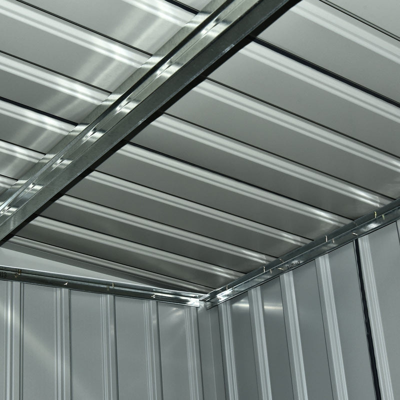 View up at the shed's internal roof structure showing the steel purlins and ribbed roof panels
