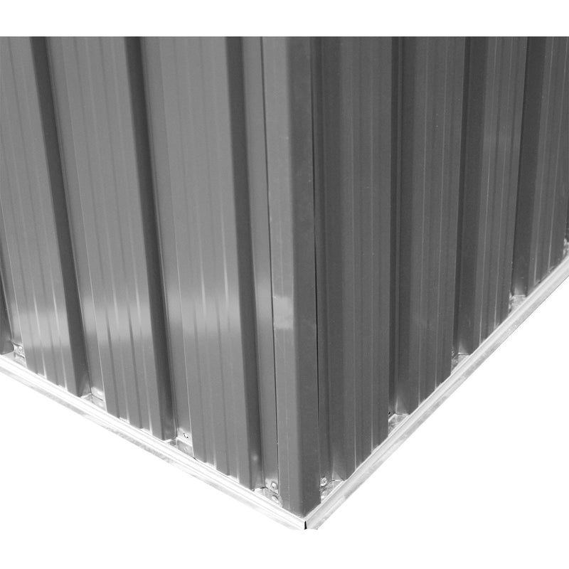 Inside corner of the shed showing the ribbed steel wall panels meeting the base rail