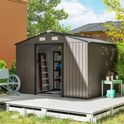 Brown 9x6ft shed against a brick house wall with doors open and a decorative cart wheel