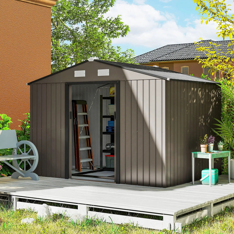 Brown 9x6ft shed against a brick house wall with doors open and a decorative cart wheel