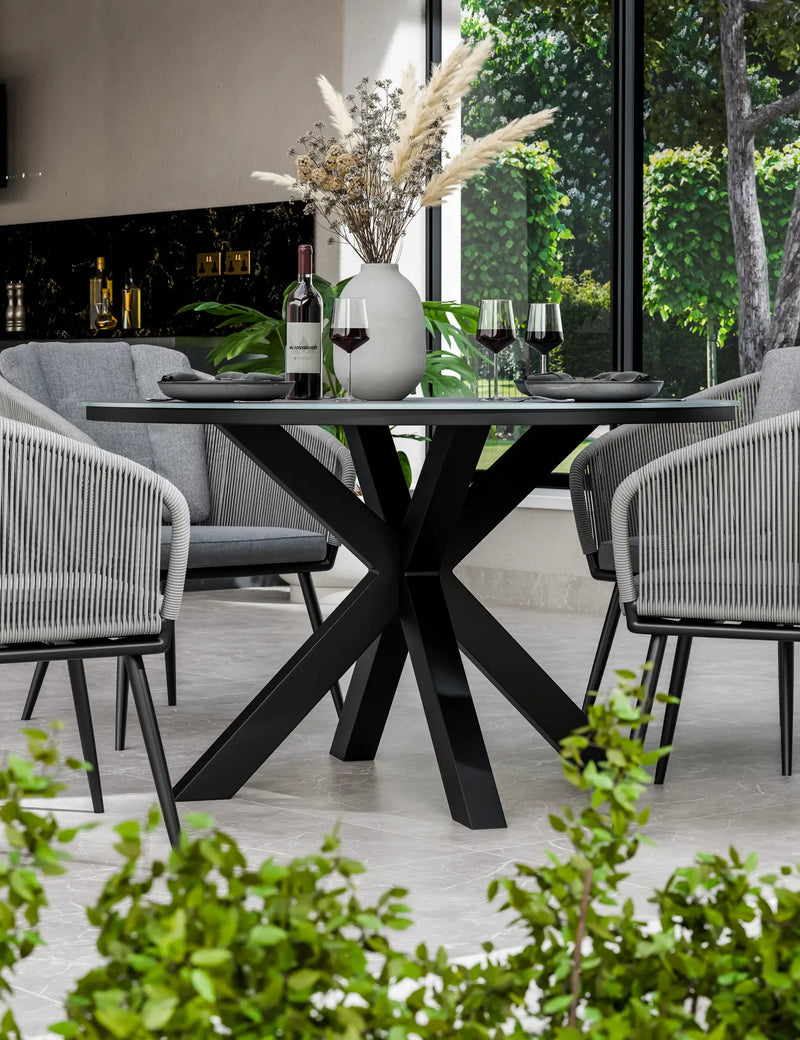 Aspen 120cm round ceramic dining table and grey rope chairs on a patio