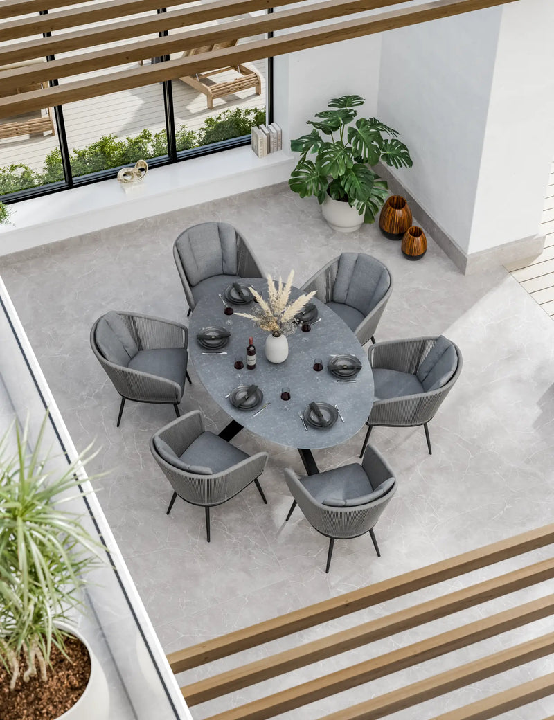 Aspen 6 seater oval ceramic glass garden dining set seen from above, grey top with six rope chairs