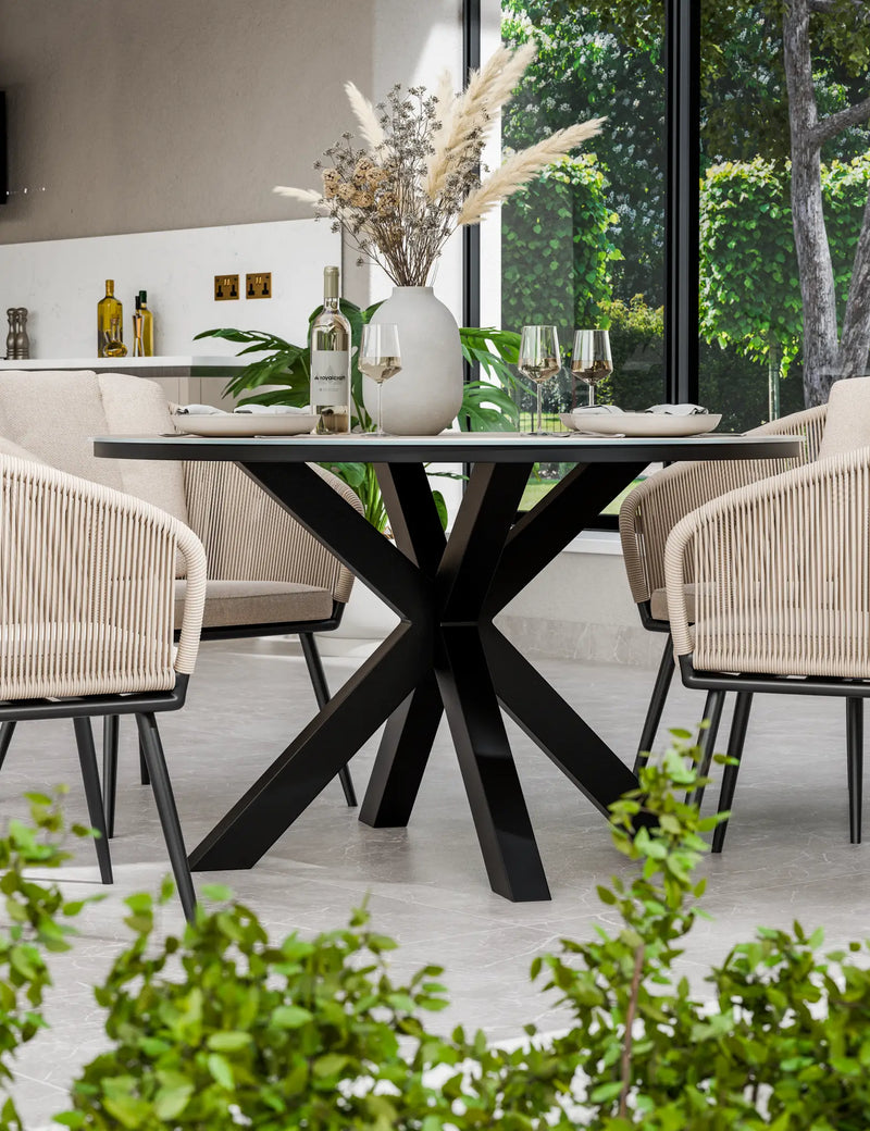 Bali 120cm round natural ceramic dining table and sandstone rope chairs on a patio