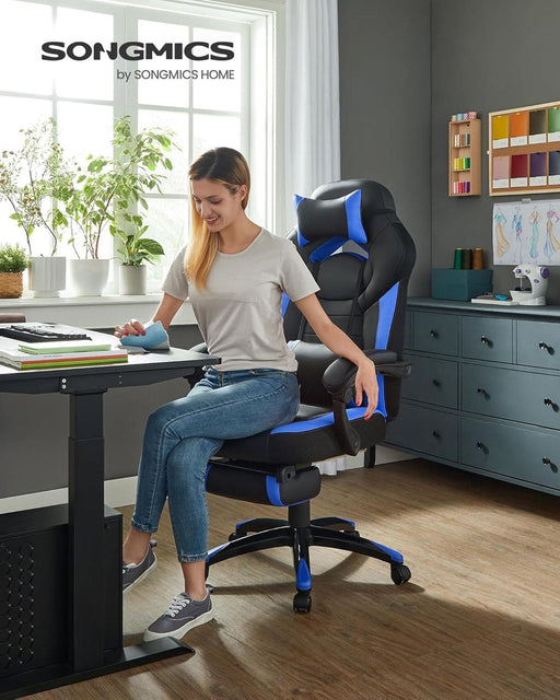 Image of a blue and black gaming chair. This ergonomic gaming chair has a footrest, padded arms for extra support, adjustable lumbar support pillow, neck pillow, swivel wheels, an adjustable backrest, and adjustable height.