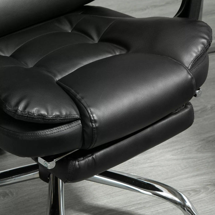 Image of a black leather executive office chair on wheels with armrests, and a retractable footrest for home office