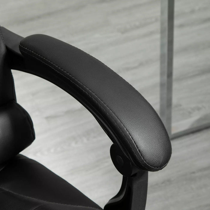 Image of a black leather executive office chair on wheels with armrests, and a retractable footrest for home office