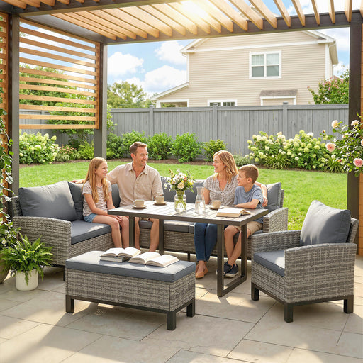 Family sitting outdoors on patio furniture with a table and chairs.