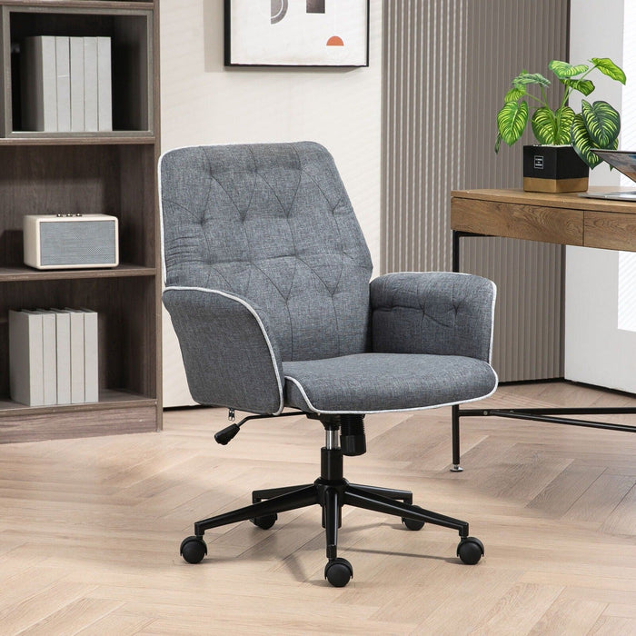 Image of a modern office desk chair upholstered in a stylish grey linen. The desk chair has a mid back with button tufting, armrests, swivel wheels, and adjustable height and backrest. This comfortable office chair is modern for yoru home office.