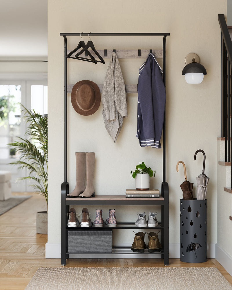 Greige and Black coat rack in a light entryway with a hat, umbrellas and boots