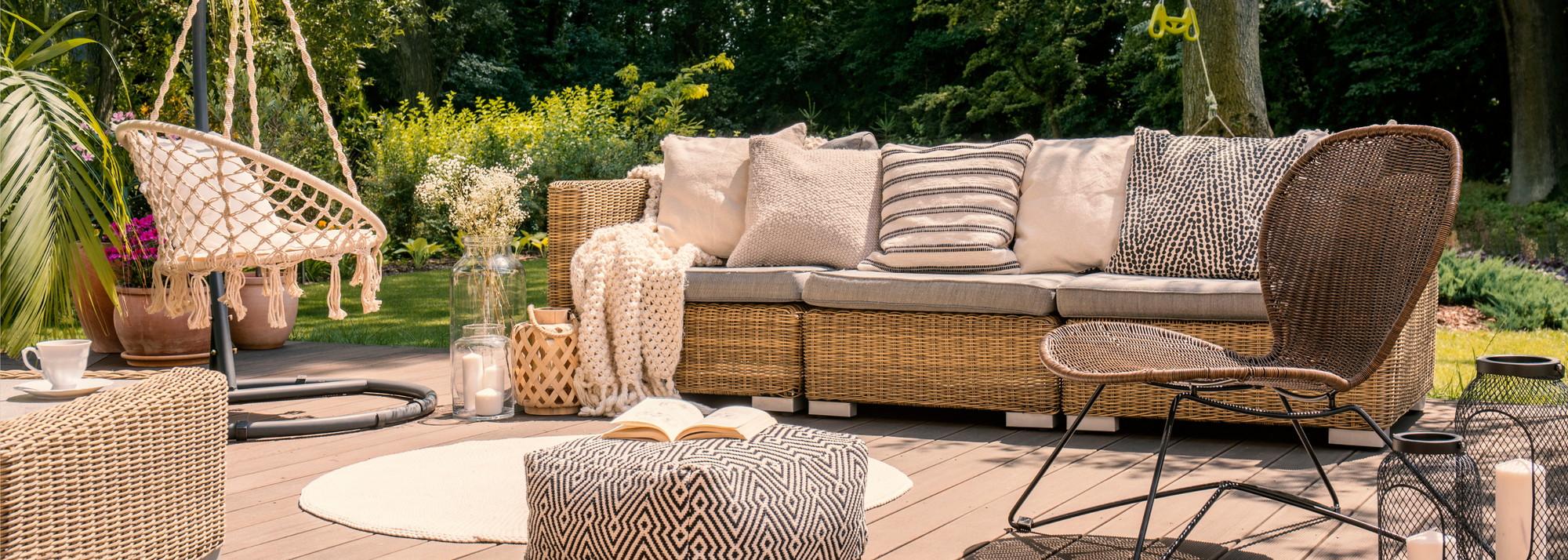 Image of a cosy garden scene with modern rattan patio furniture.