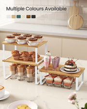 Cupboard organiser risers arranged in L-shape on kitchen worktop
