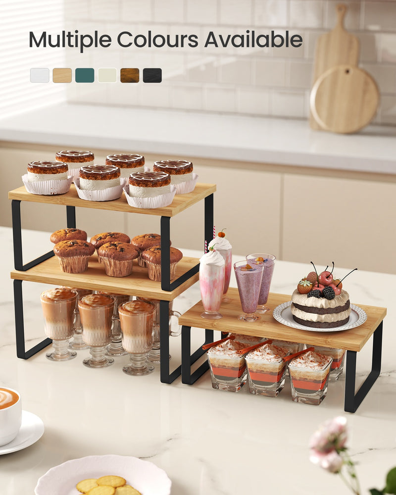 Black cupboard organiser risers arranged in L-shape on kitchen worktop