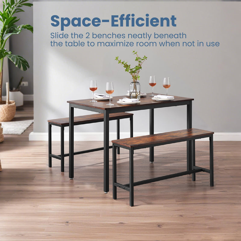 Dining table with two benches in a bright dining room with wine glasses on the table