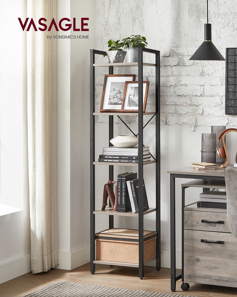 Heather greige bookcase standing beside a desk against an exposed brick wall