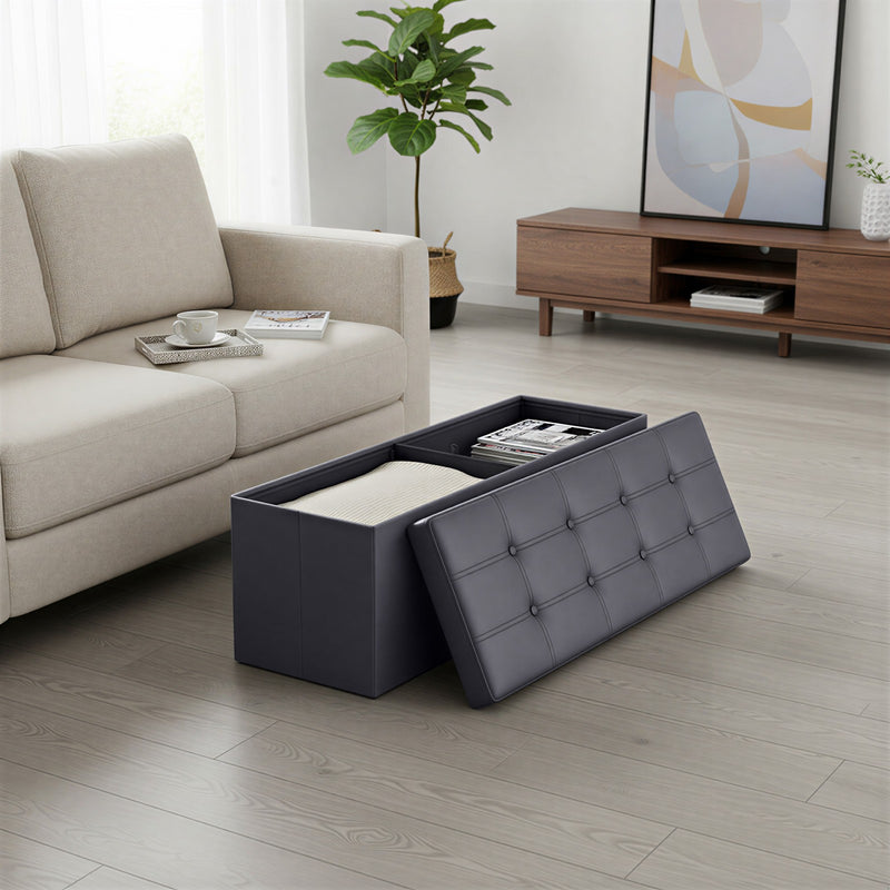 Person sitting on slate grey folding storage ottoman