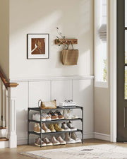 3-tier shoe rack fully loaded with shoes on each fabric shelf