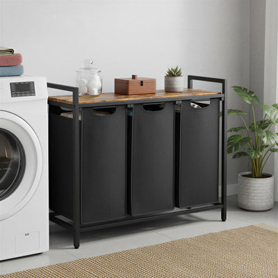 Laundry room with a black 3 section laundry sorter and wooden top, washing machine on the left.