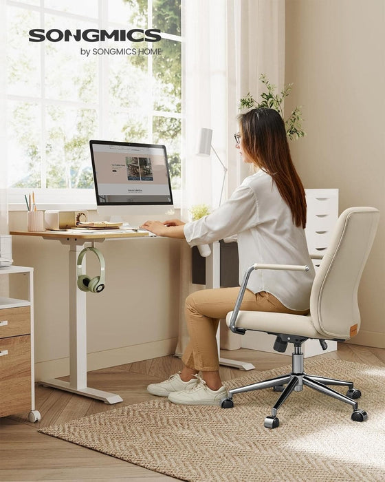 Image of a modern office chair with wheels wrapped in beige faux leather with arms on a chrome swivel base with wheels. The chair looks modern and stylish.