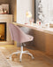 Image of a Modern Velvet Office Chair With Wheels. This is pink with white swivel wheels.