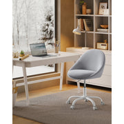Image of a Modern Velvet Office Chair With Wheels. This is grey with white swivel wheels.