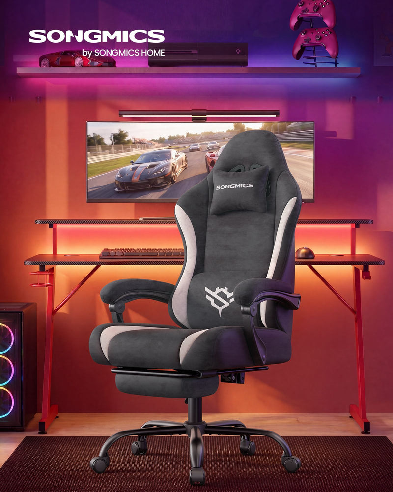 Dark Carbon Grey gaming chair reclined with footrest extended in a gaming desk setup