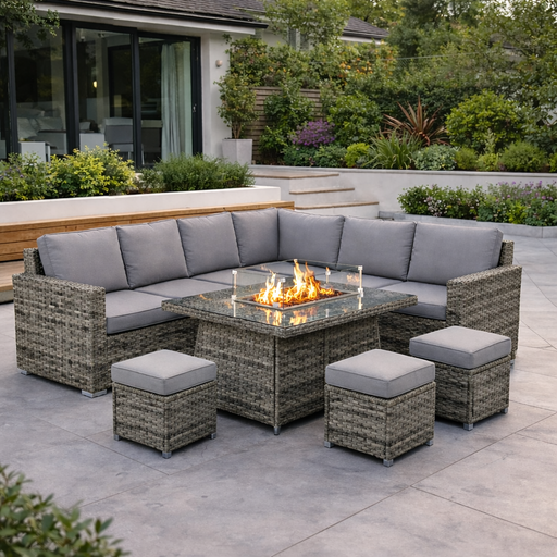 Outdoor patio set with fire pit table on a patio area with greenery.