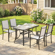 Outdoor patio set with table and chairs on a paved patio