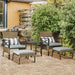 Image of a rattan patio furniture set consisting of 2 khaki coloured armchairs with grey seat cushions, 2 footstools and a coffee table with a shelf