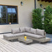 Image of a 5 Seater Grey Rattan Corner Sofa Set with Tables & Cushions on a wooden deck