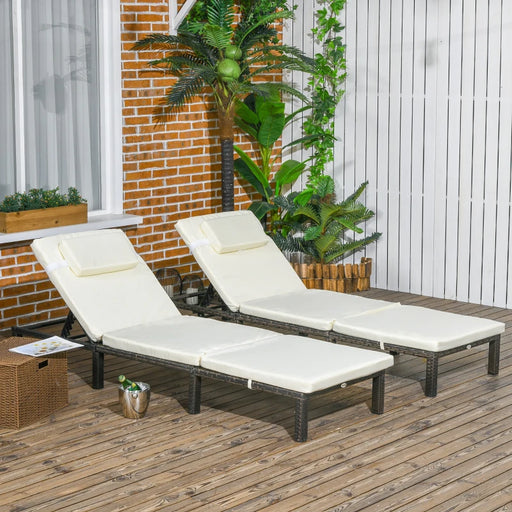 Image of a set of 2 brown rattan sun loungers with cream cushions and reclining backrests