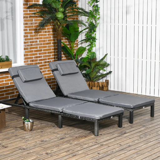 Image of a set of 2 grey rattan sun loungers with dark grey cushions and reclining backrests